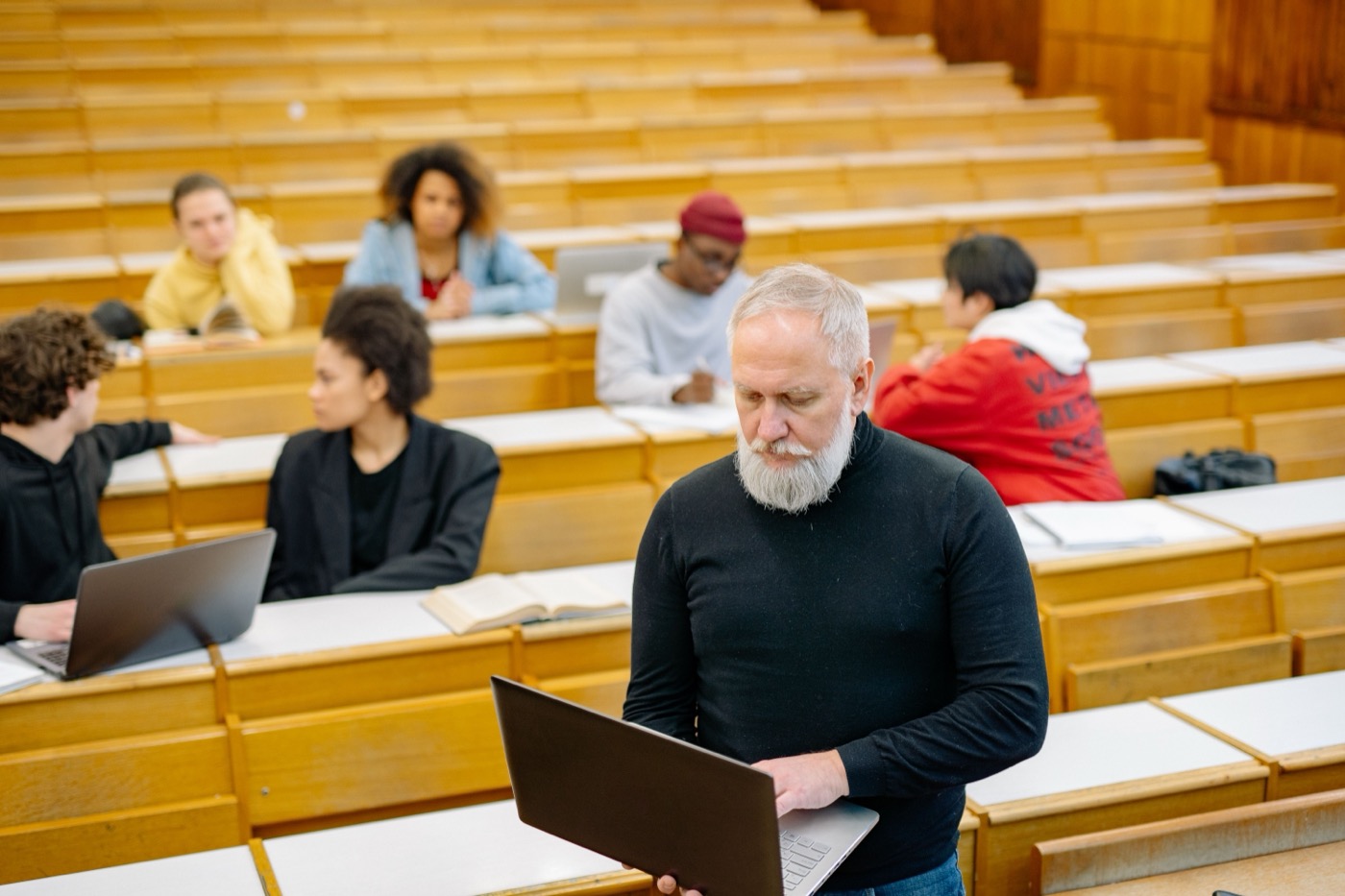 Professor and students working in a university classroom